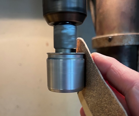sanding brake caliper piston in drill press