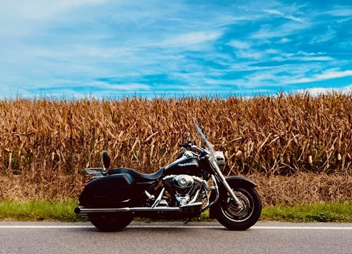 motorcycle parked next to a corn field best motorcycle destinations