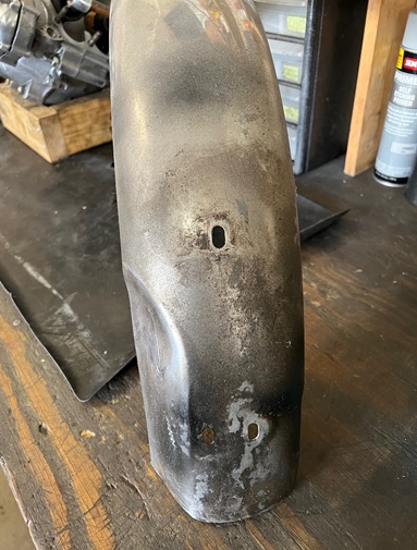 renew fender bolt holes with hammer and dolly