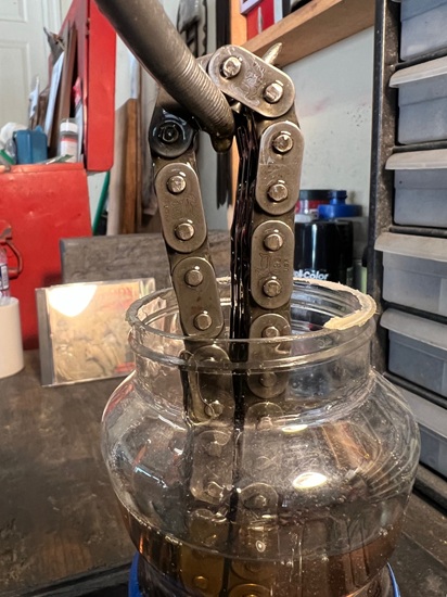 old primary chain in jar of oil
